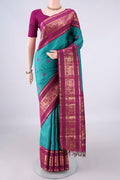 Pure Silk Turquoise Kanchipuram Saree with Thread Butta on the body and Zari Border.  displayed on a mannequin