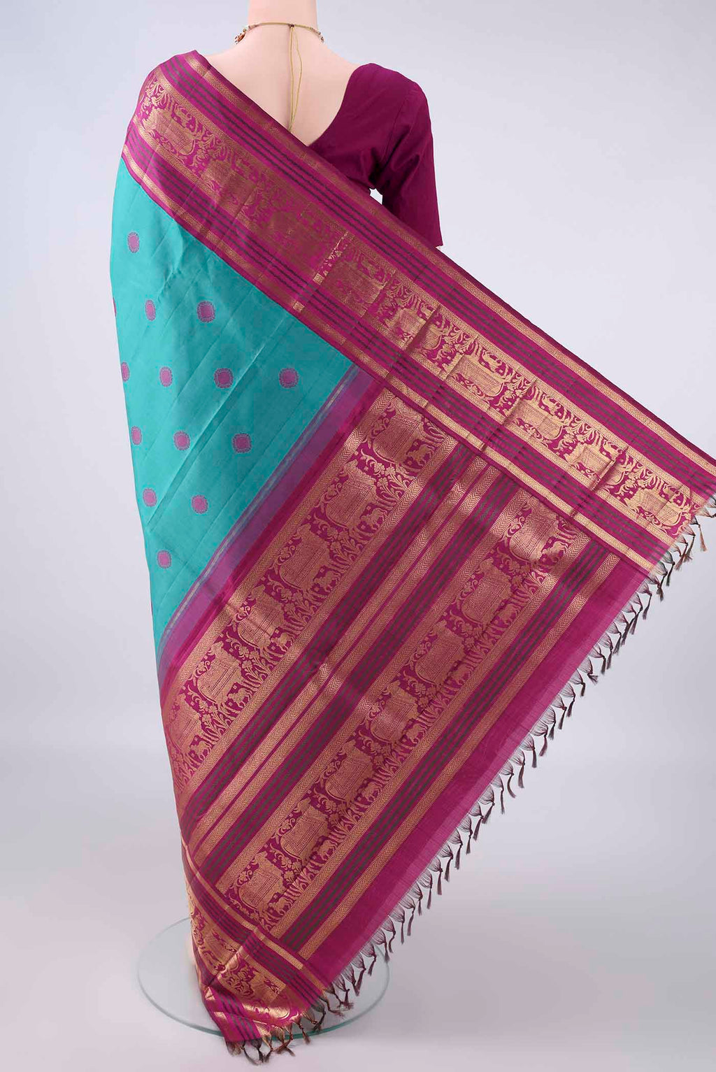 Flat view of Pure Silk Turquoise Kanchipuram Saree with Thread Butta on the body and Zari Border. 