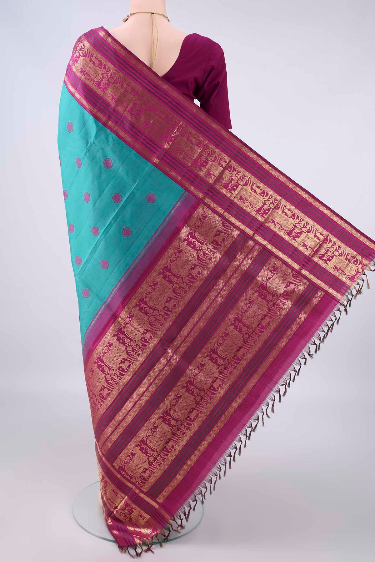 Flat view of Pure Silk Turquoise Kanchipuram Saree with Thread Butta on the body and Zari Border. 