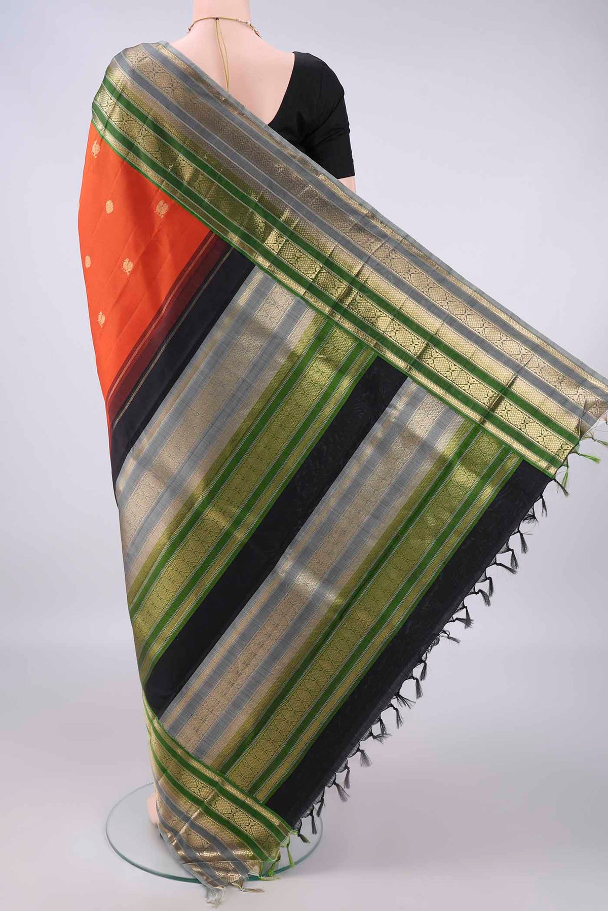 Flat view of Pure Silk Orange Kanchipuram Saree with Zari Butta on the body and Zari Border. 