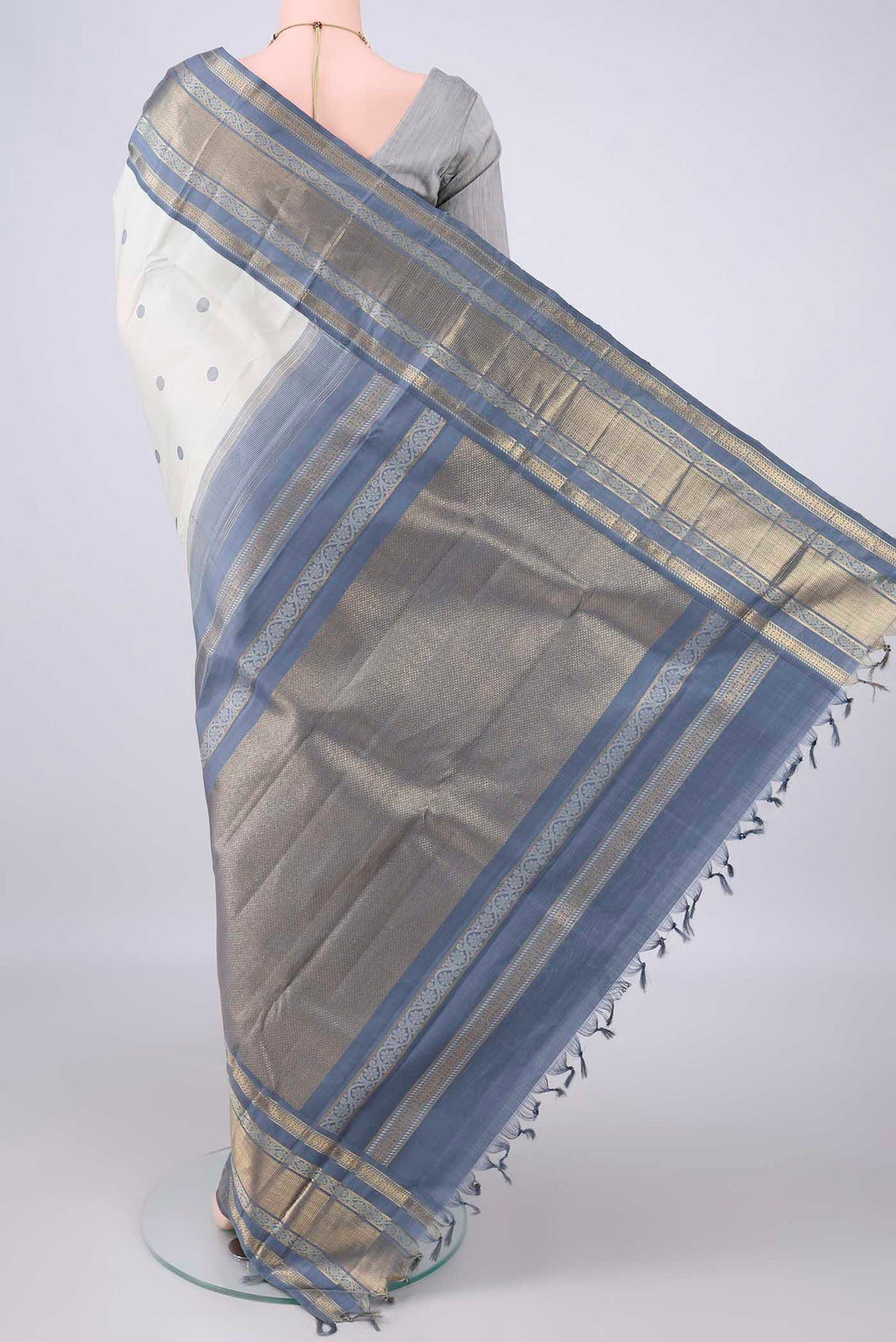 Flat view of Pure Silk Off White Kanchipuram Saree with Thread Butta on the body and Zari Border. 