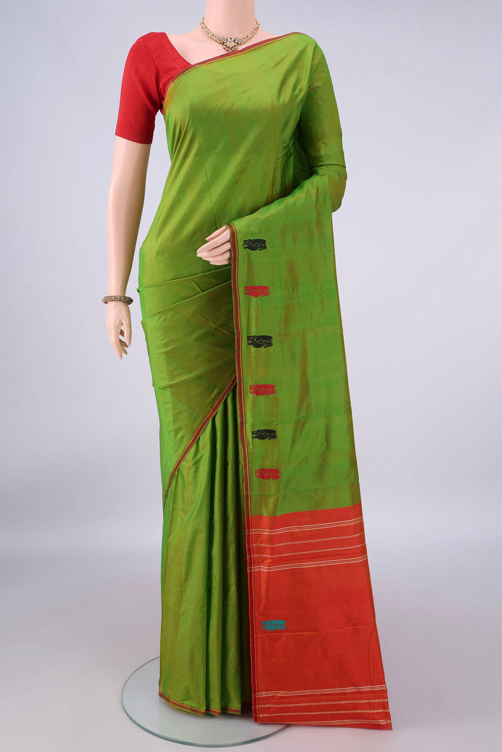 Pure Silk Green Kanchipuram Saree with Plain Body and Zari Border.  displayed on a mannequin