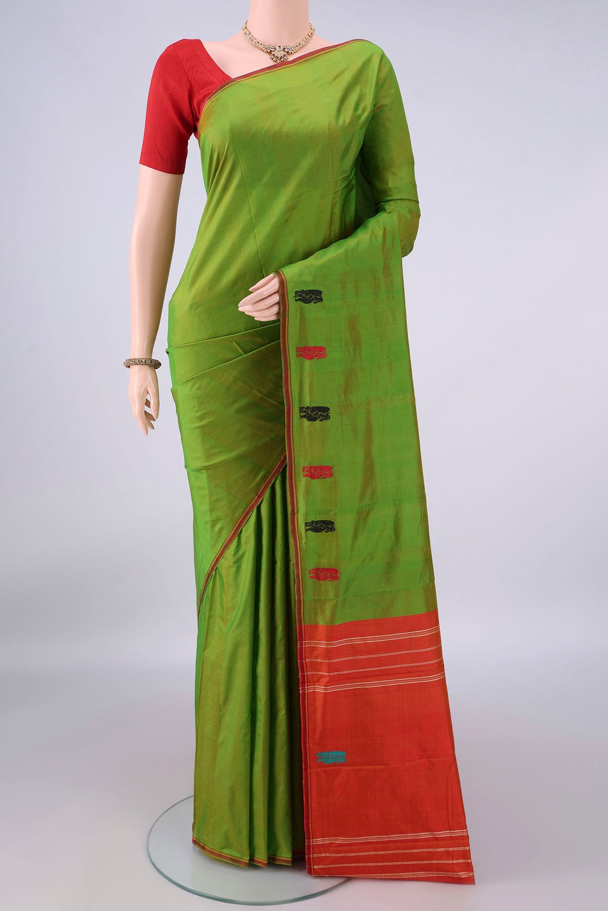 Pure Silk Green Kanchipuram Saree with Plain Body and Zari Border.  displayed on a mannequin