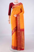 Pure Silk Yellow Kanjivaram Saree with Zari Butta on the body and Zari Border.  displayed on a mannequin