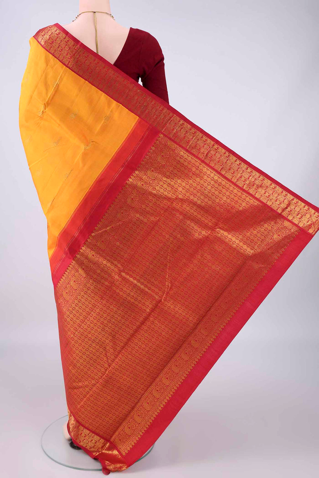 Flat view of Pure Silk Yellow Kanjivaram Saree with Zari Butta on the body and Zari Border. 