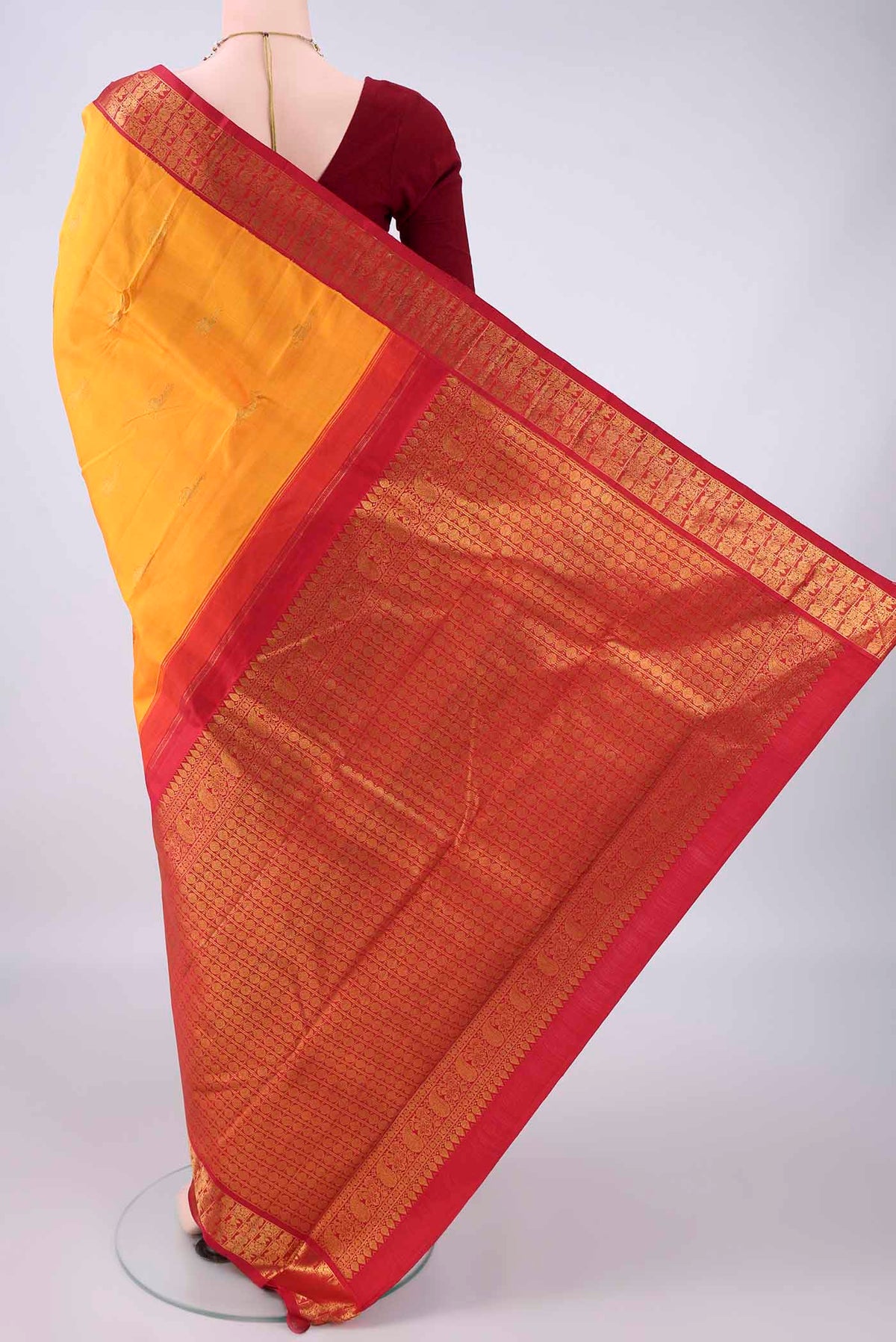 Flat view of Pure Silk Yellow Kanjivaram Saree with Zari Butta on the body and Zari Border. 