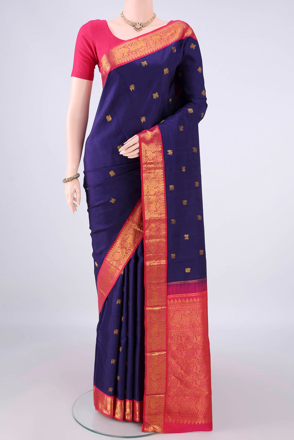 Pure Silk Navy Blue Kanjivaram Saree with Zari Butta on the body and Zari Border.  displayed on a mannequin