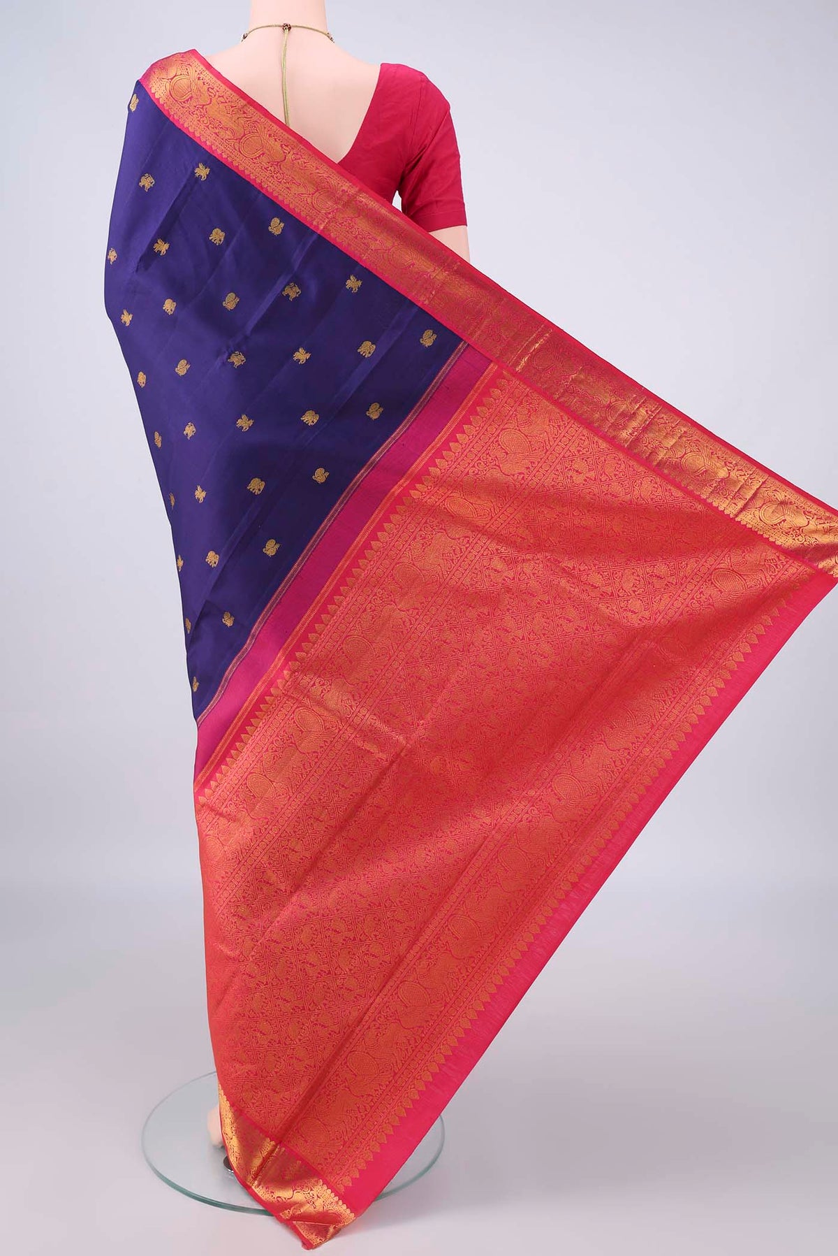 Flat view of Pure Silk Navy Blue Kanjivaram Saree with Zari Butta on the body and Zari Border. 