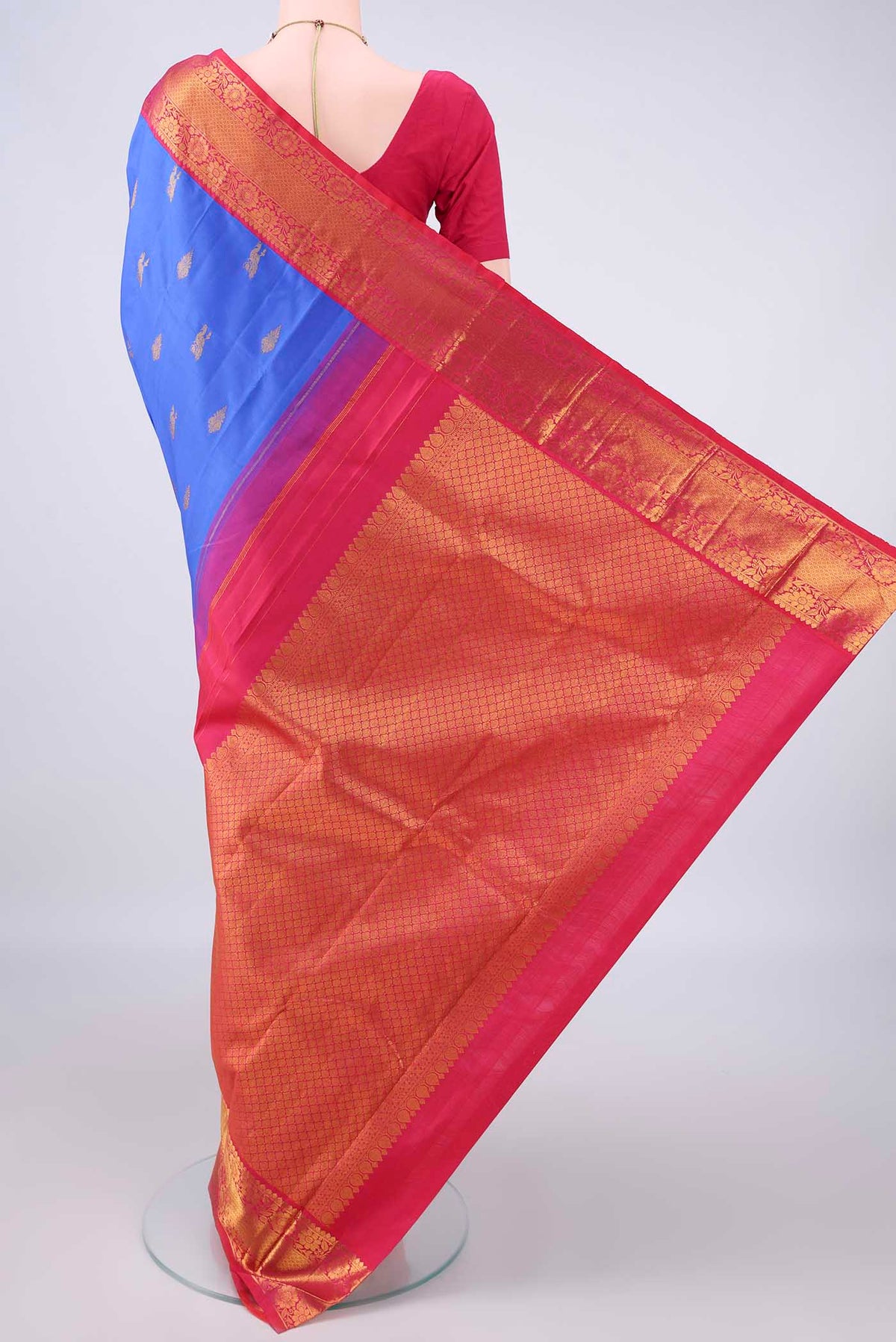 Flat view of Pure Silk Royal Blue Kanjivaram Saree with Zari Butta on the body and Zari Border. 