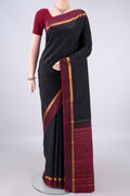 Pure Silk Black Kanjivaram Saree with Zari Butta on the body and Zari Border.  displayed on a mannequin