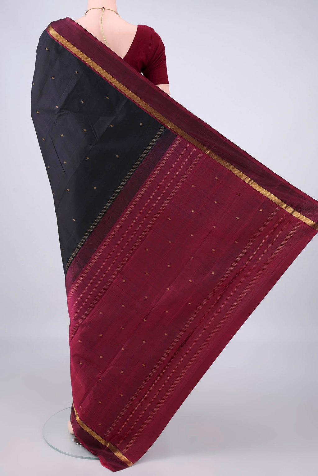 Flat view of Pure Silk Black Kanjivaram Saree with Zari Butta on the body and Zari Border. 