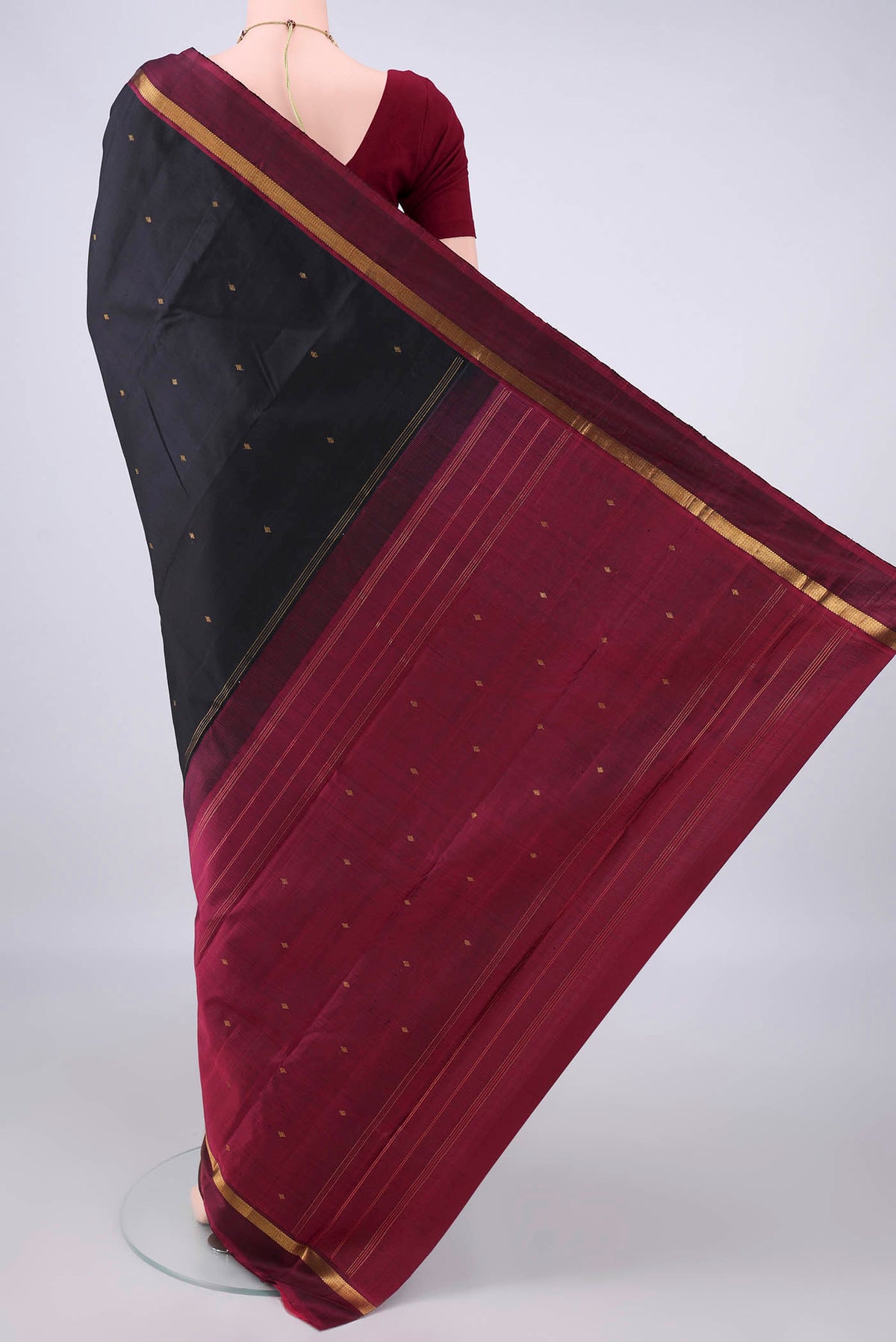 Flat view of Pure Silk Black Kanjivaram Saree with Zari Butta on the body and Zari Border. 