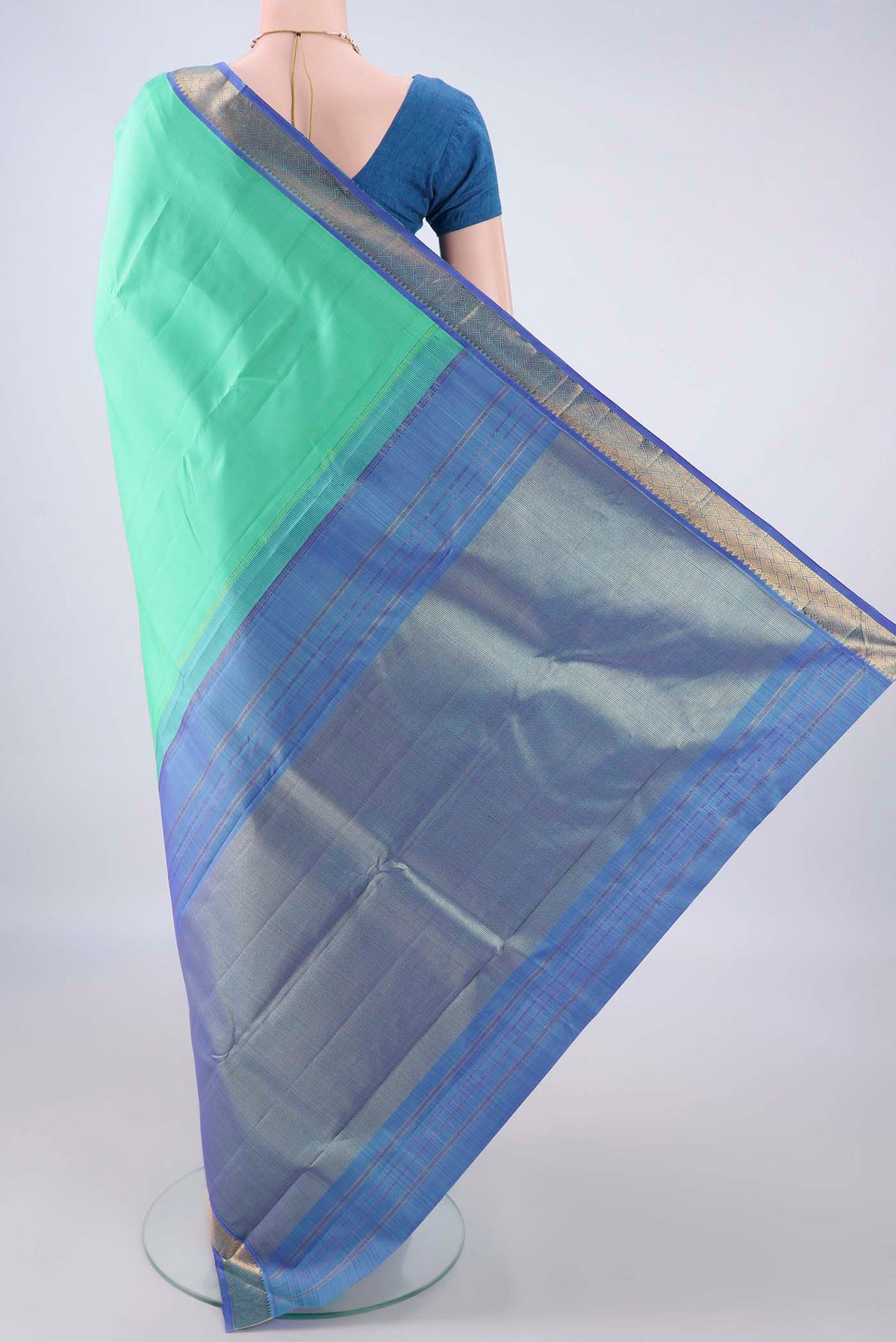 Flat view of Pure Silk Sea Green Kanchipuram Saree with Plain Body and Zari Border. 