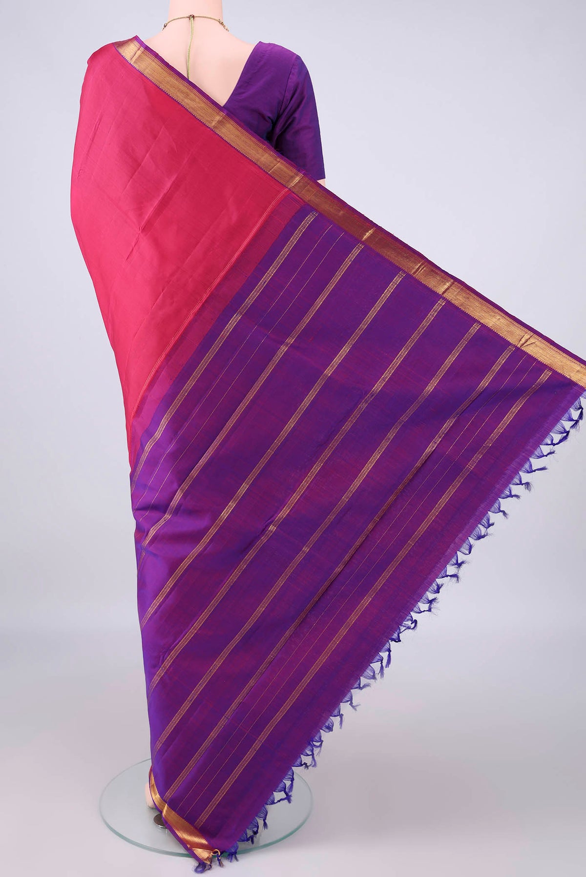 Flat view of Pure Silk Coral Kanjivaram Saree with Plain Body and Zari Border. 