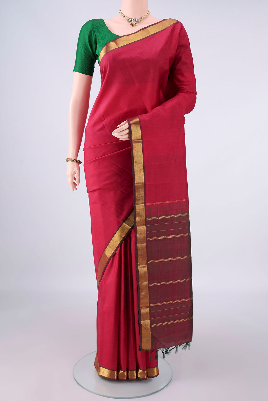 Pure Silk Red Kanjivaram Saree with Plain Body and Zari Border.  displayed on a mannequin