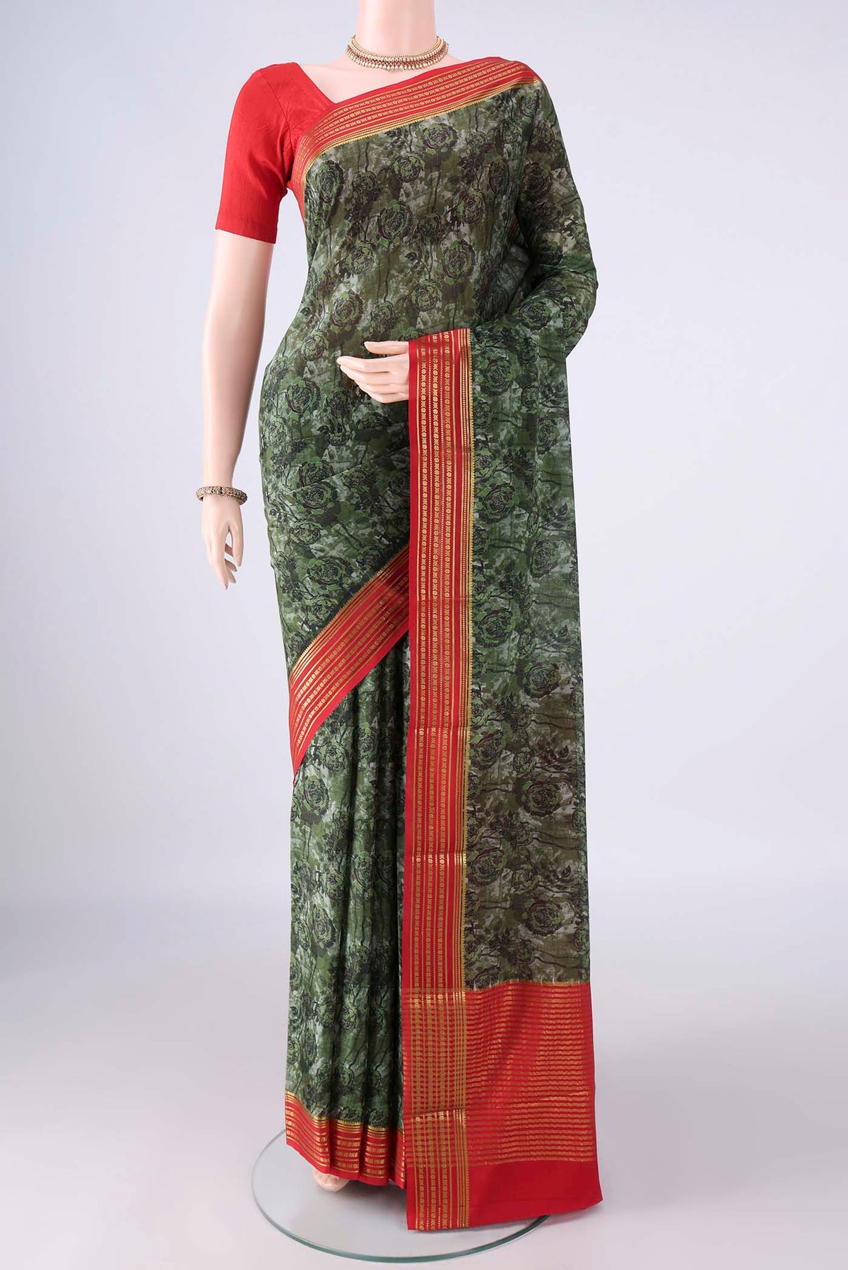 Green Mysore Crepe Saree with Printed design on the body and Zari Border.  displayed on a mannequin