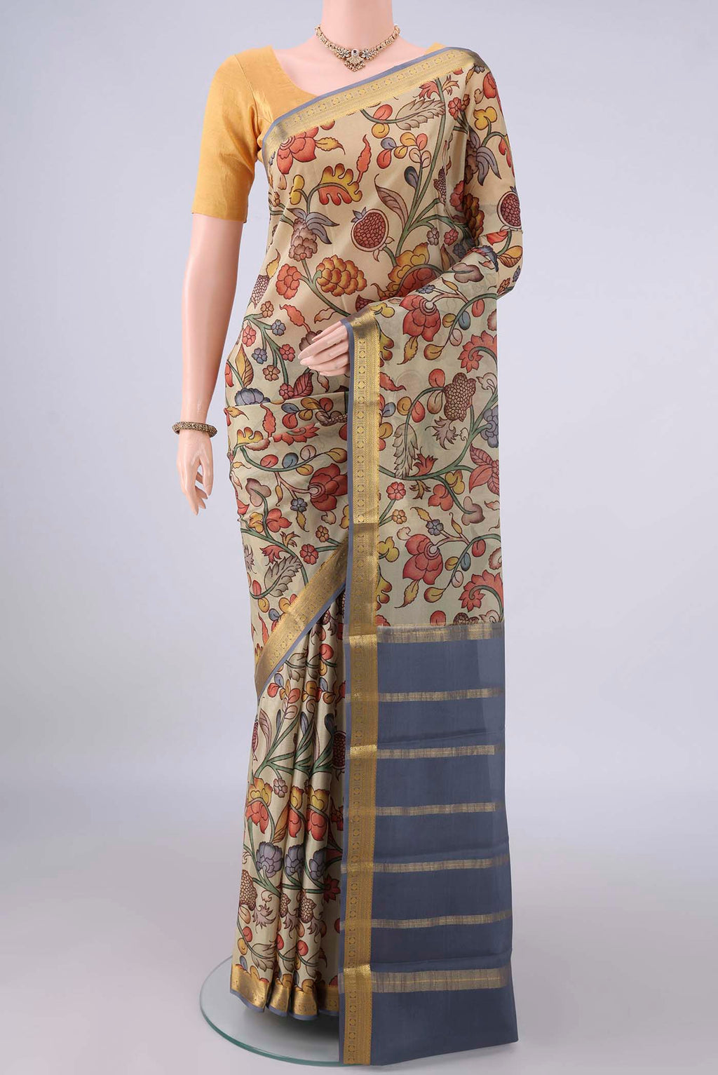 Dark Beige Mysore Crepe Saree with Printed design on the body and Zari Border.  displayed on a mannequin