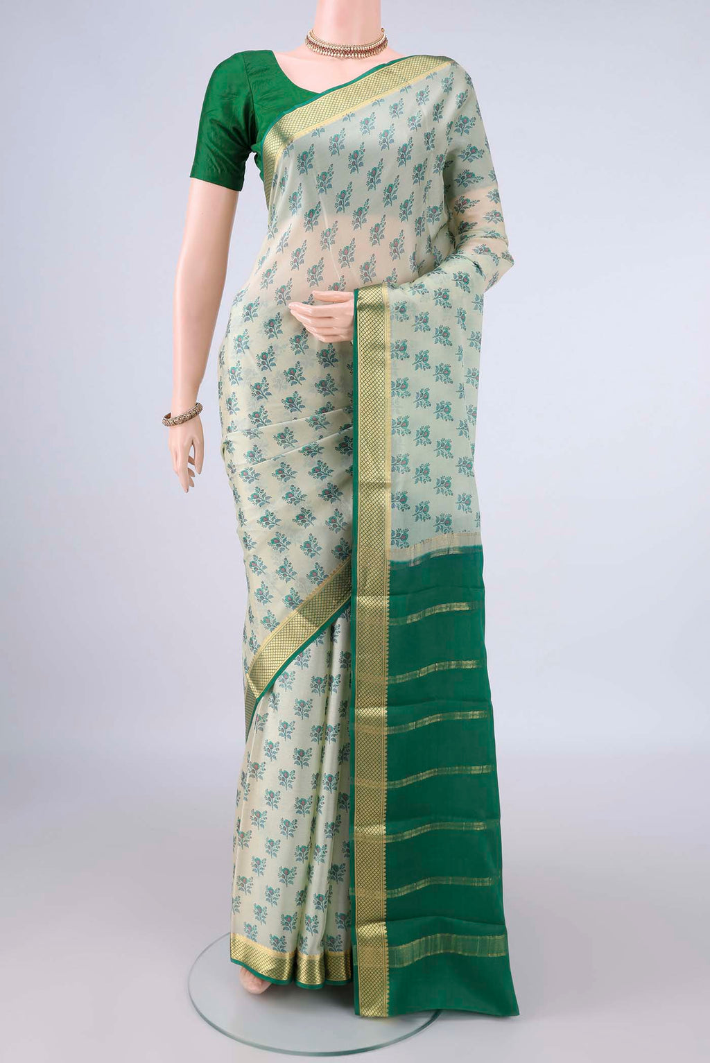 Off White Mysore Crepe Saree with Printed design on the body and Zari Border.  displayed on a mannequin