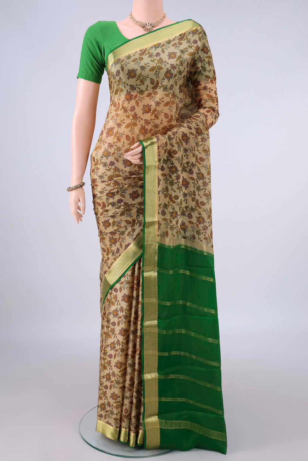 Dark Beige Mysore Crepe Saree with Printed design on the body and Zari Border.  displayed on a mannequin