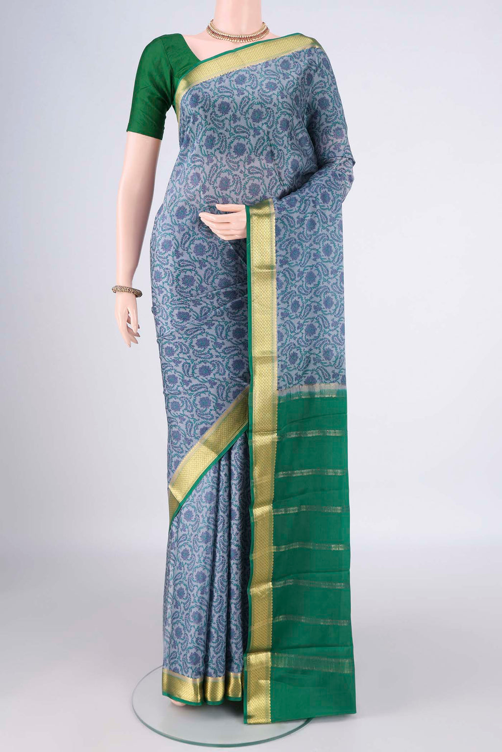 Grey Mysore Crepe Saree with Printed design on the body and Zari Border.  displayed on a mannequin