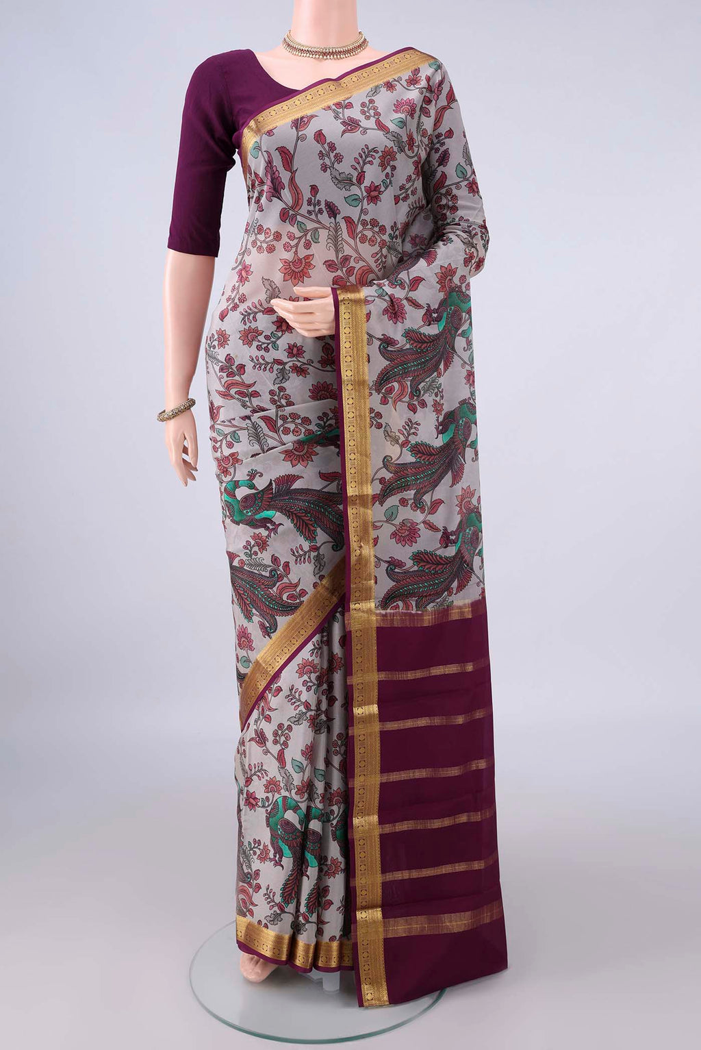 Grey Mysore Crepe Saree with Printed design on the body and Zari Border.  displayed on a mannequin