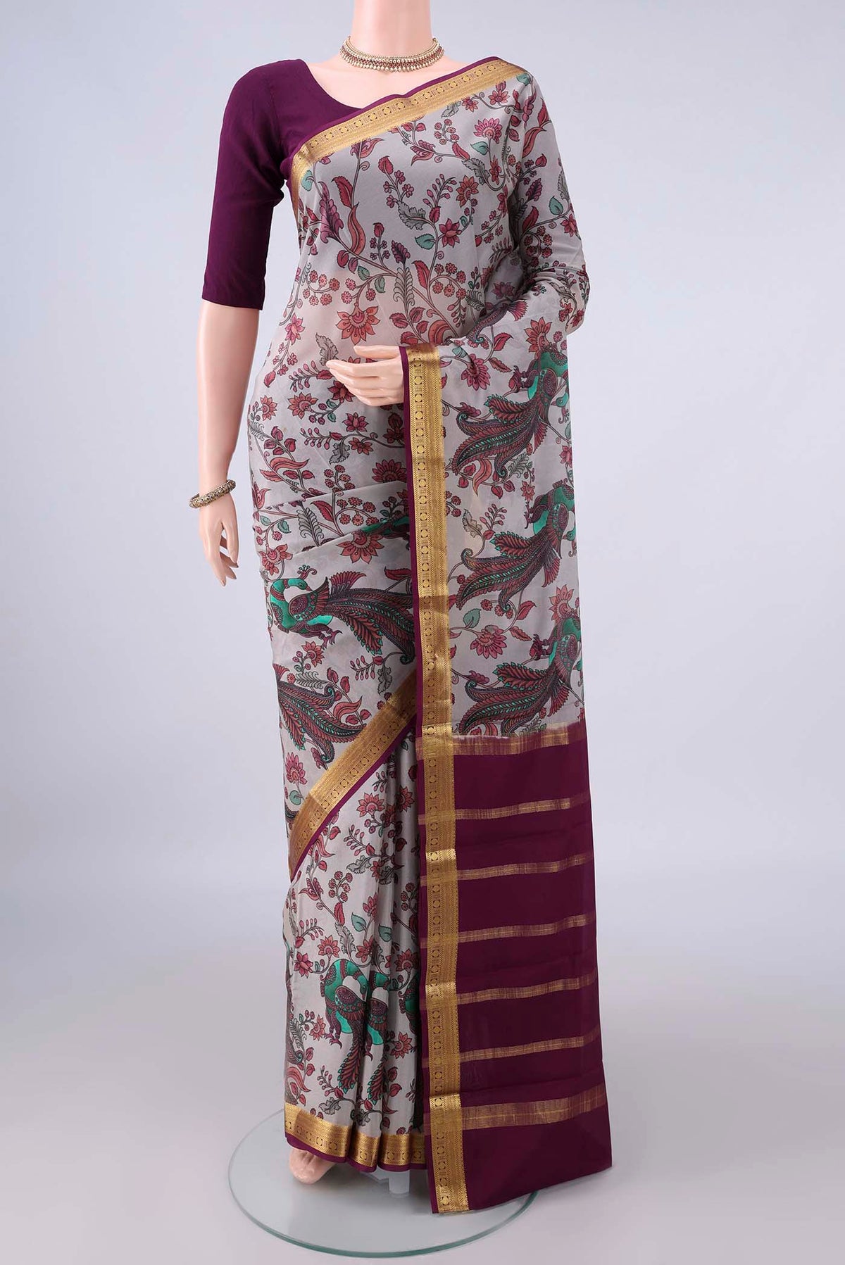 Grey Mysore Crepe Saree with Printed design on the body and Zari Border.  displayed on a mannequin