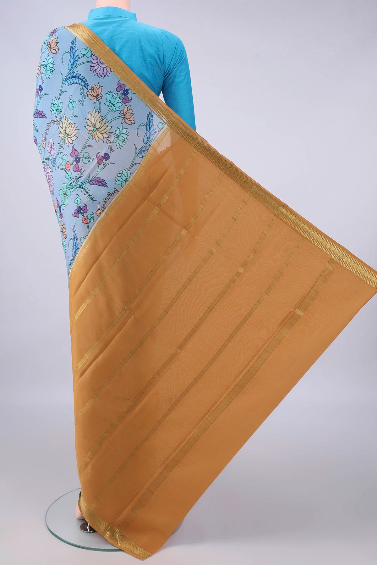 Flat view of Blue Grey Mysore Crepe Saree with Printed design on the body and Zari Border. 