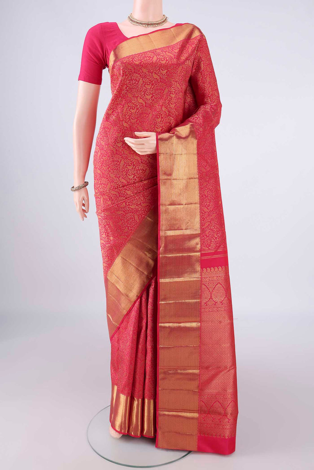 Pure Silk Dark Pink Kanchipuram Saree with Zari Brocade on the body and Zari Border.  displayed on a mannequin