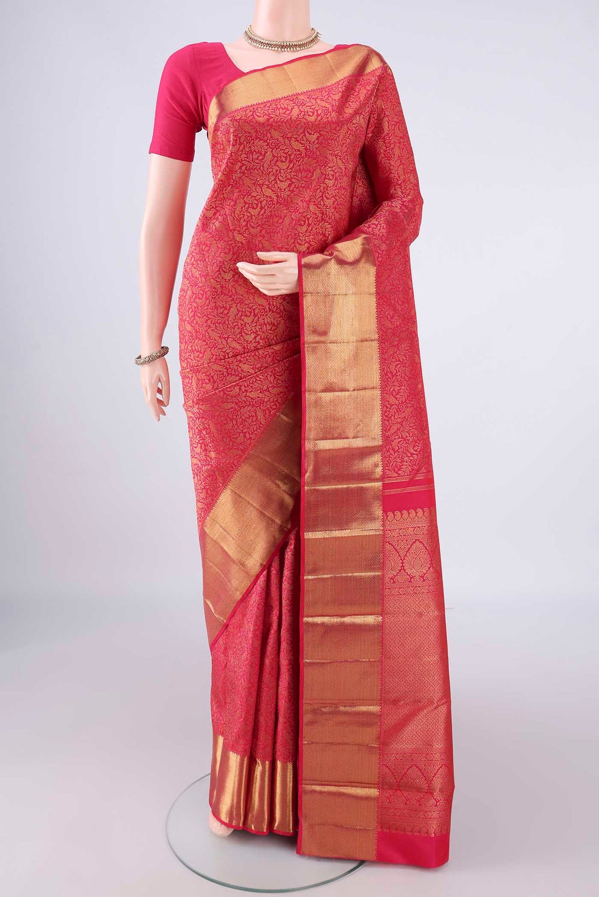 Pure Silk Dark Pink Kanchipuram Saree with Zari Brocade on the body and Zari Border.  displayed on a mannequin