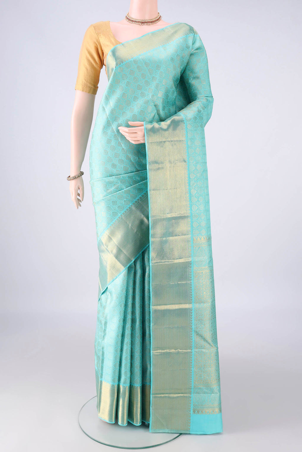 Pure Silk Turquoise Kanchipuram Saree with Zari Brocade on the body and Zari Border.  displayed on a mannequin