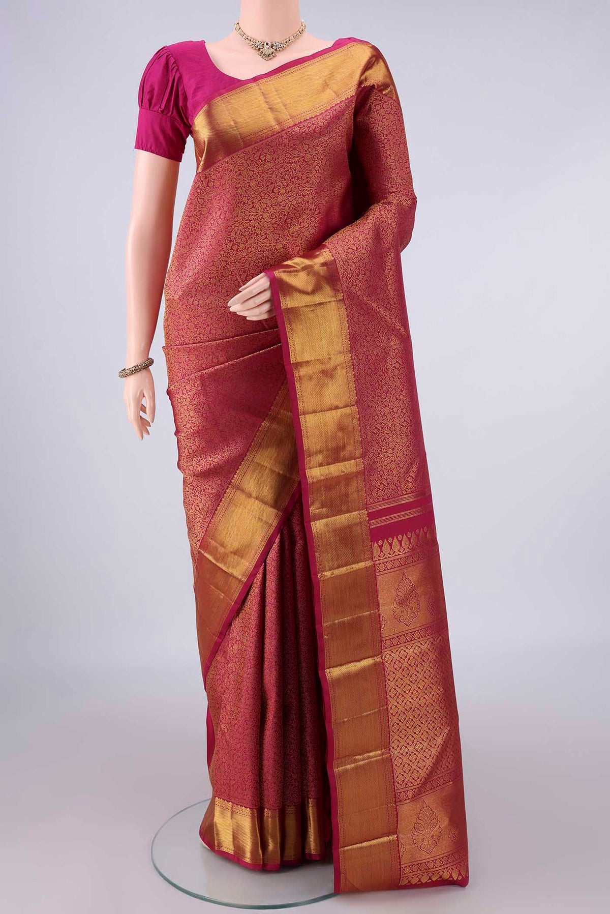 Pure Silk Dark Pink Kanchipuram Saree with Zari Brocade on the body and Zari Border.  displayed on a mannequin