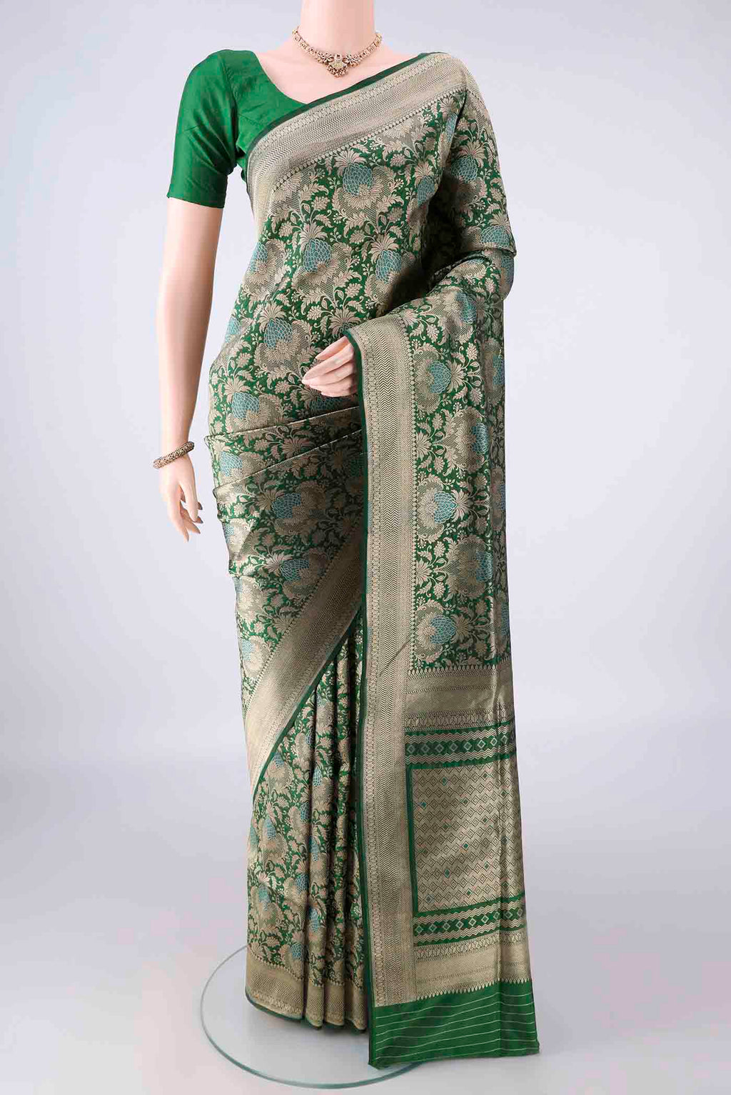 Pure Silk Green Banarasi Saree with Zari Brocade on the body and Zari Border.  displayed on a mannequin