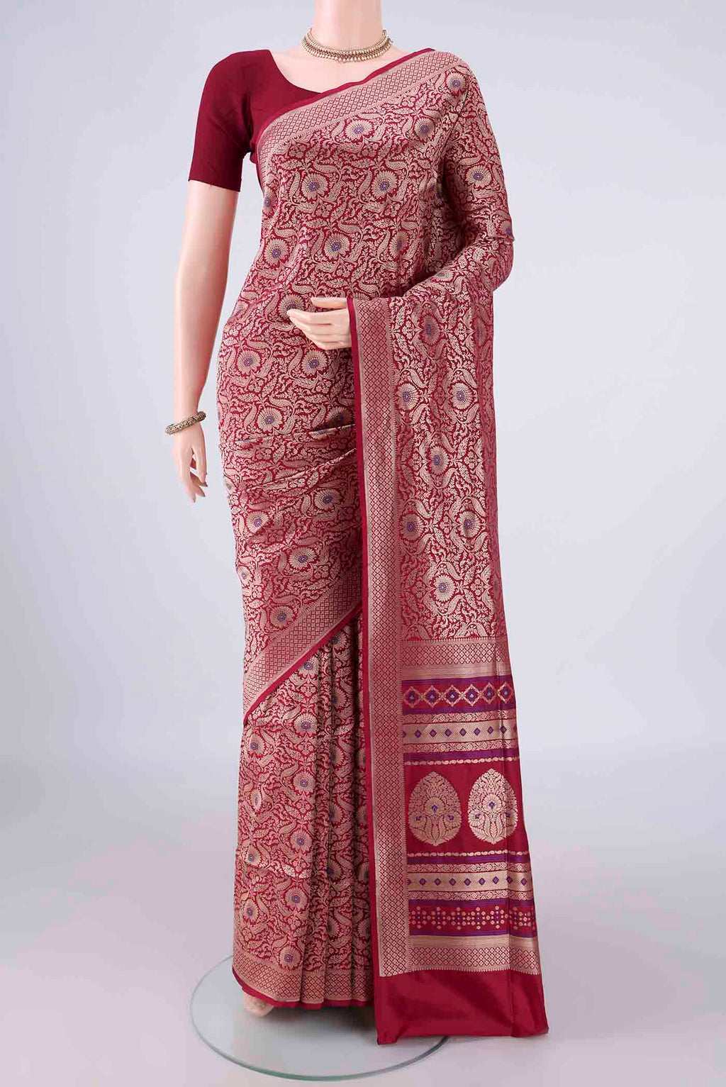 Pure Silk Maroon Banarasi Saree with Zari Brocade on the body and Zari Border.  displayed on a mannequin