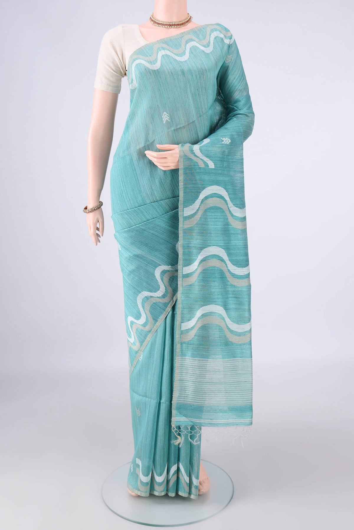 Pure Silk Sea Green Jute Saree with Jamdani on the body and Plain Border.  displayed on a mannequin