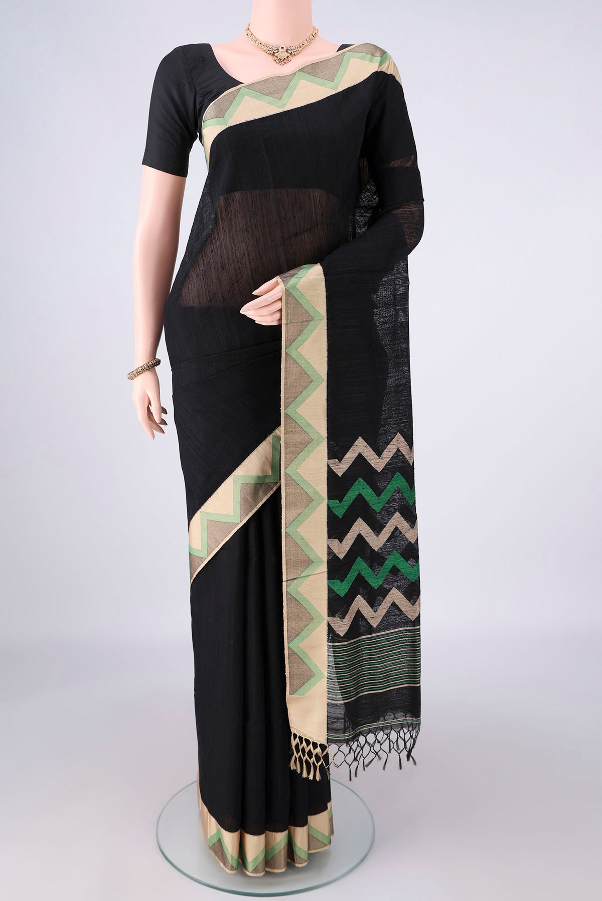 Pure Silk Black Jute Saree with Plain Body and Thread Border.  displayed on a mannequin
