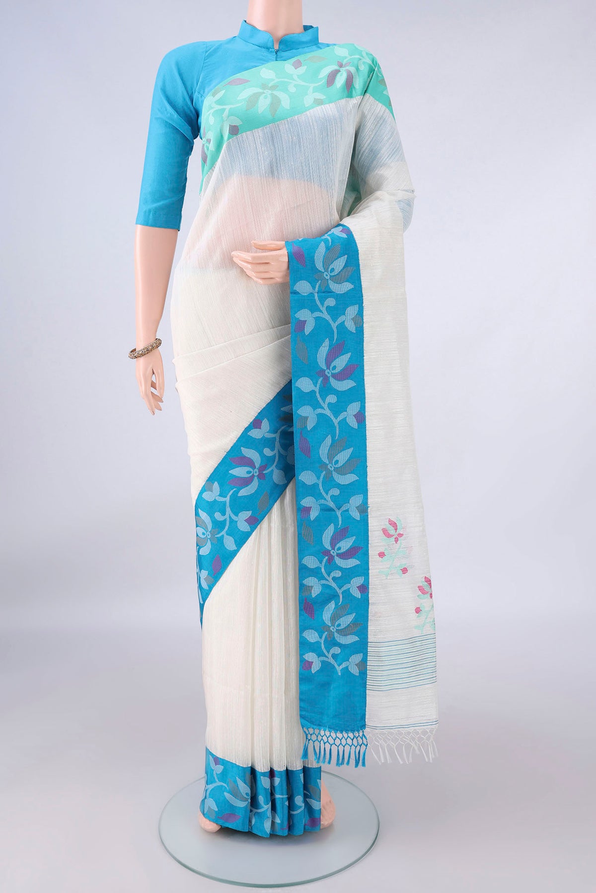 Pure Silk White Jute Saree with Jamdani on the body and Ganga Jamuna Border.  displayed on a mannequin