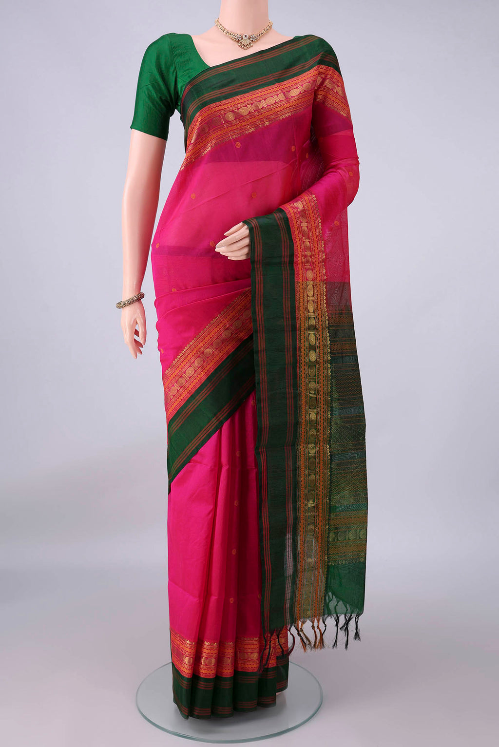 Rani Pink Coimbatore Cotton Saree with Thread Butta on the body and Zari Border.  displayed on a mannequin