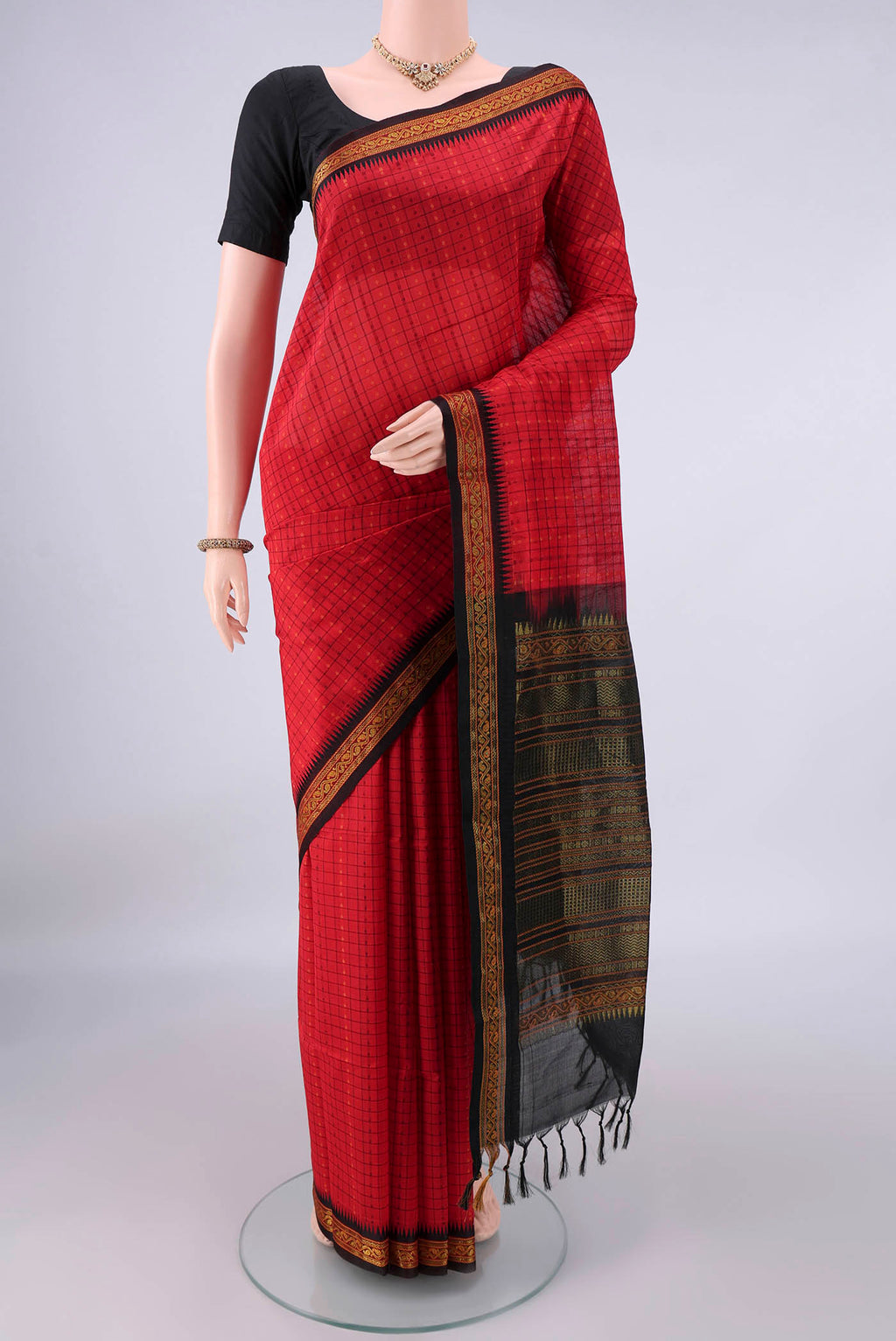 Red Coimbatore Cotton Saree with Checked design on the body and Thread Border.  displayed on a mannequin
