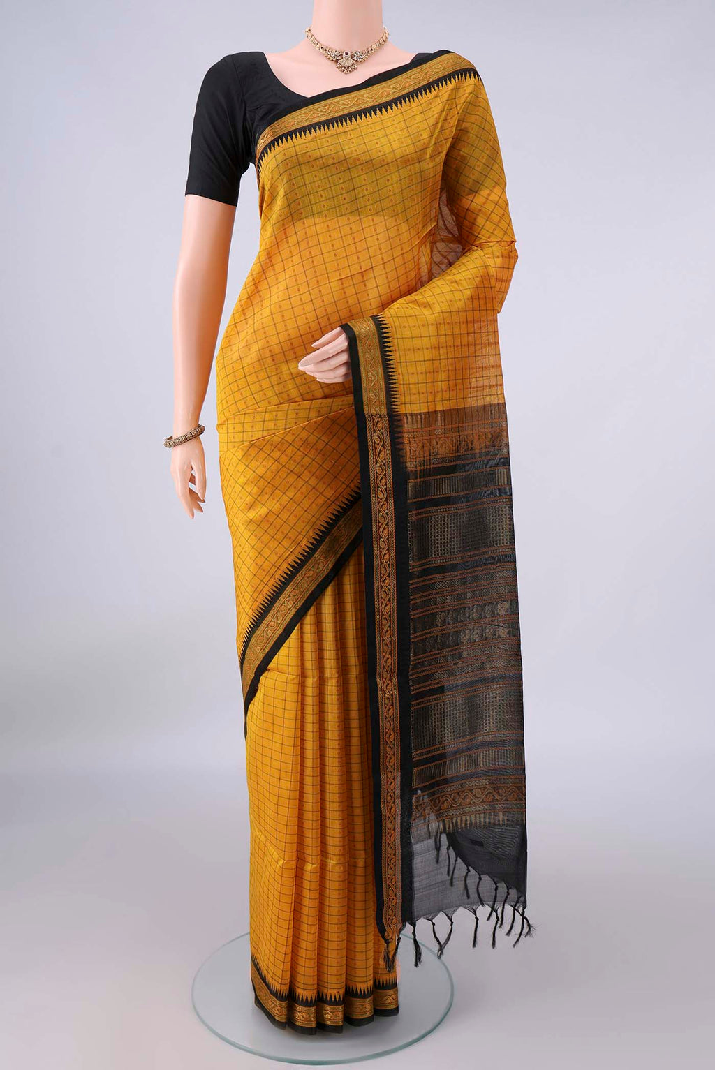 Yellow Coimbatore Cotton Saree with Checked design on the body and Thread Border.  displayed on a mannequin