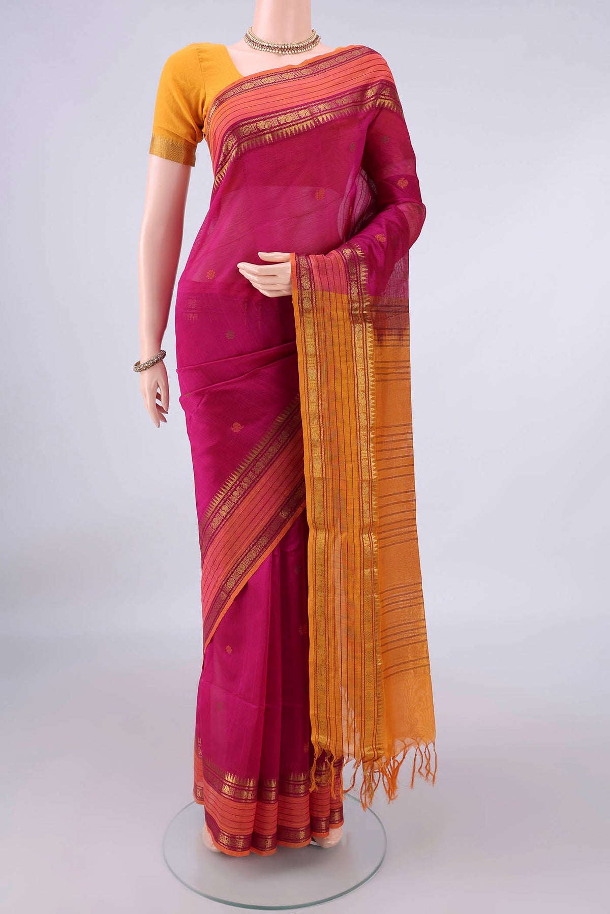 Pink Coimbatore Cotton Saree with Thread Butta on the body and Zari Border.  displayed on a mannequin