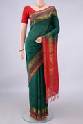 Bottle Green Coimbatore Cotton Saree with Stripes on the body and Zari Border.  displayed on a mannequin