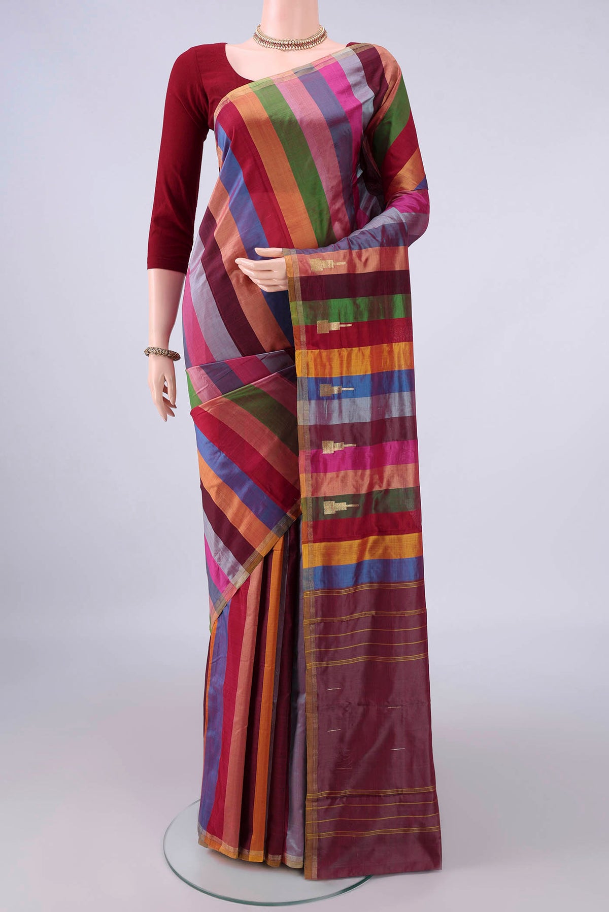 Pure Silk Multi Color Kanchipuram Saree with Stripes on the body and Zari Border.  displayed on a mannequin
