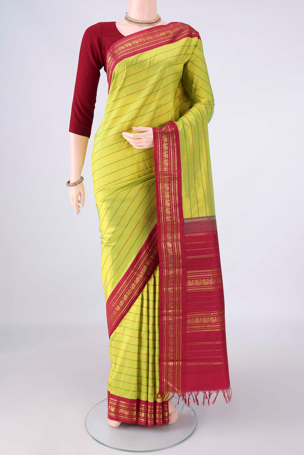 Pure Silk Parrot Green Kanchipuram Saree with Veldhari on the body and Zari Border.  displayed on a mannequin