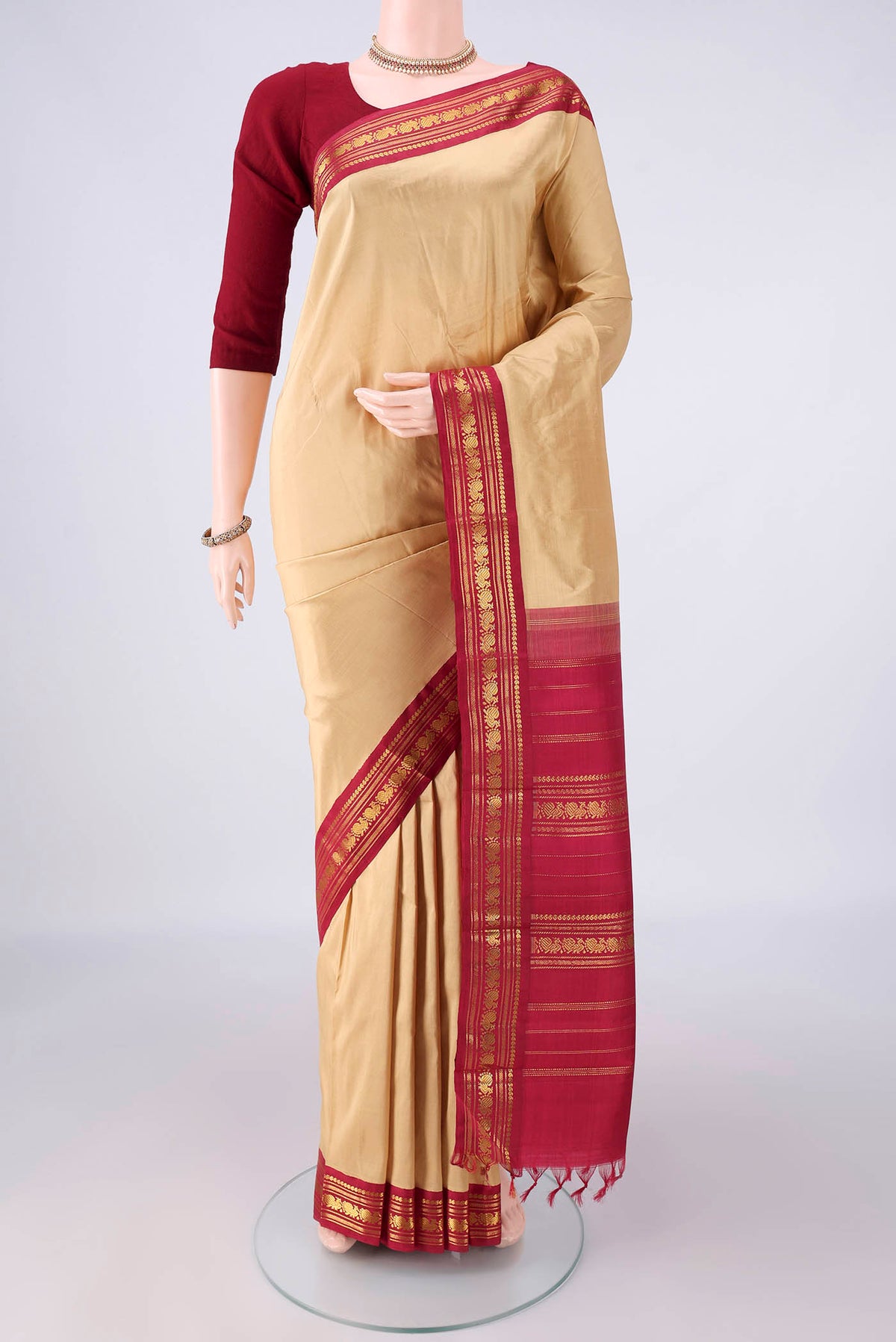 Pure Silk Sandal Kanchipuram Saree with Plain Body and Zari Border.  displayed on a mannequin