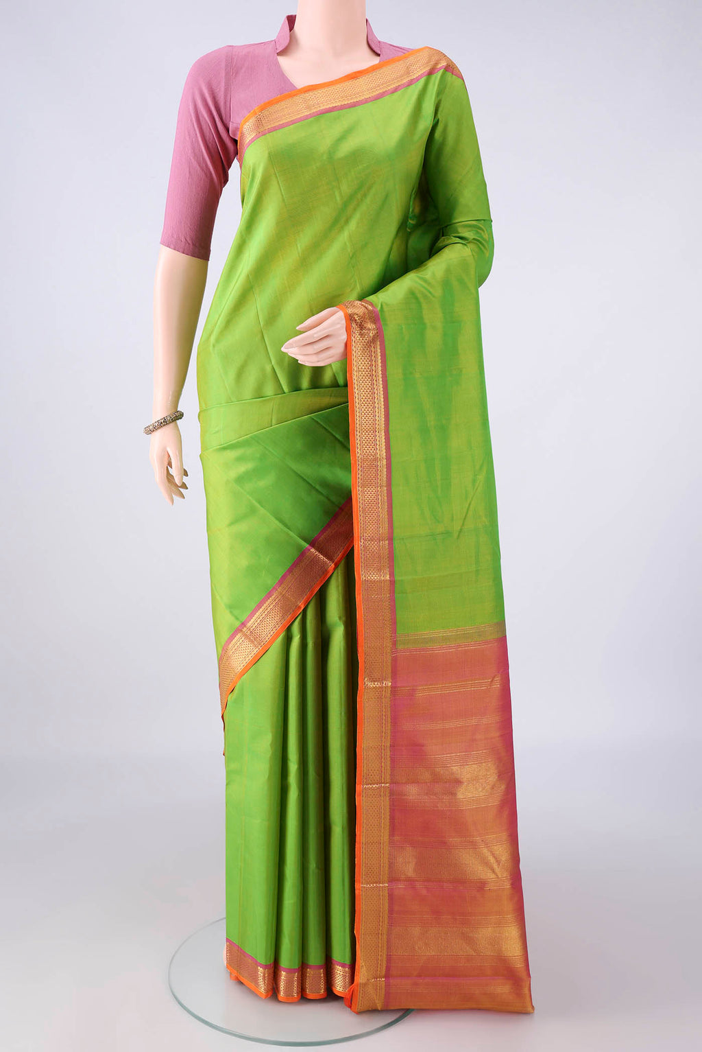 Pure Silk Parrot Green Kanchipuram Saree with Plain Body and Zari Border.  displayed on a mannequin