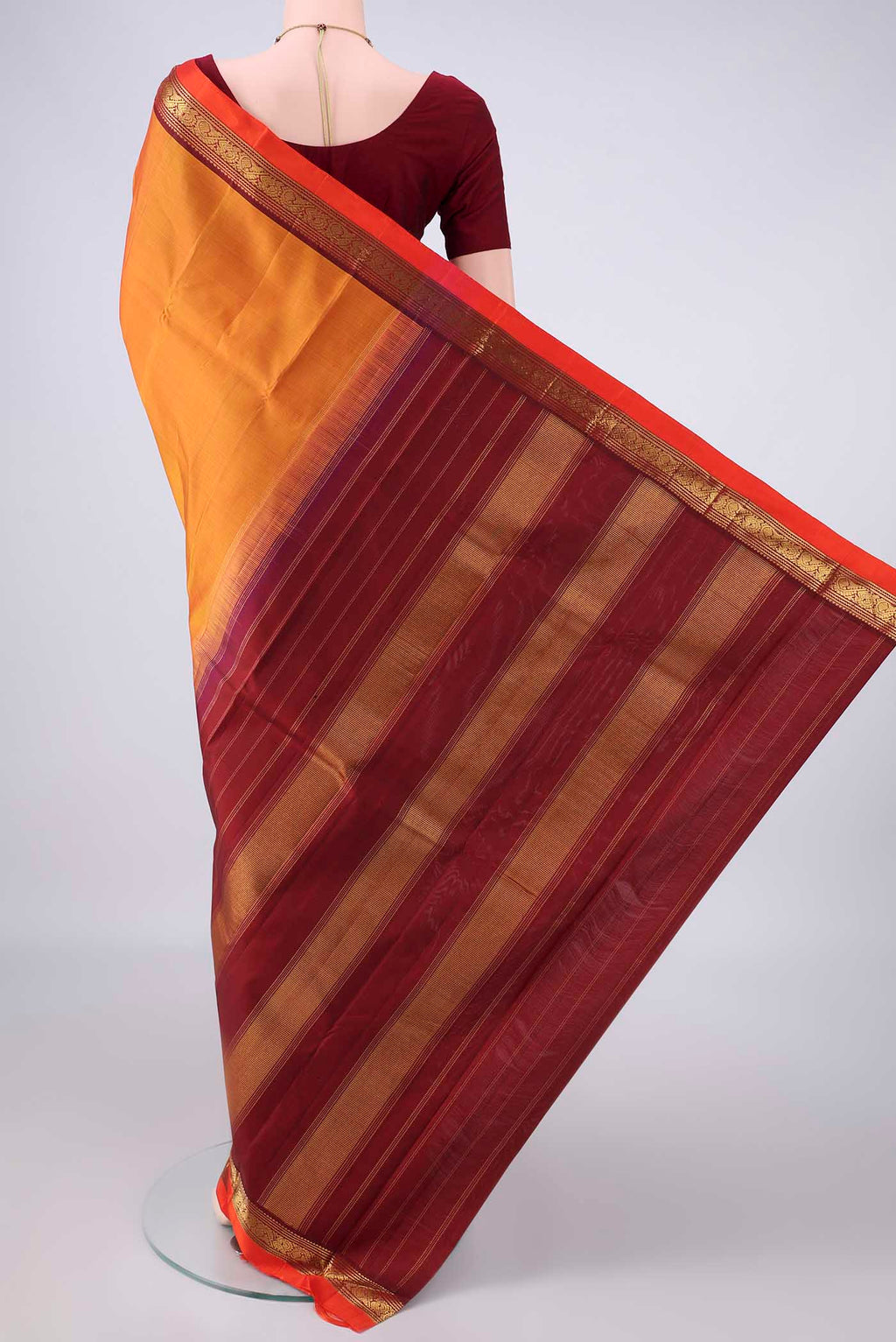 Flat view of Pure Silk Orange Kanchipuram Saree with Plain Body and Zari Border. 
