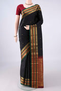 Pure Silk Black Kanjivaram Saree with Zari Butta on the body and Zari Border.  displayed on a mannequin