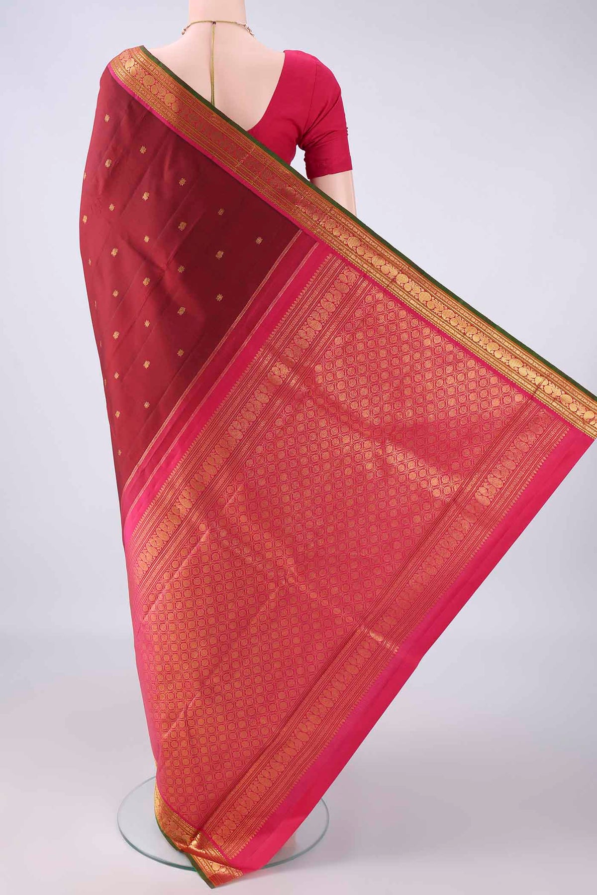 Flat view of Pure Silk Maroon Kanjivaram Saree with Zari Butta on the body and Zari Border. 