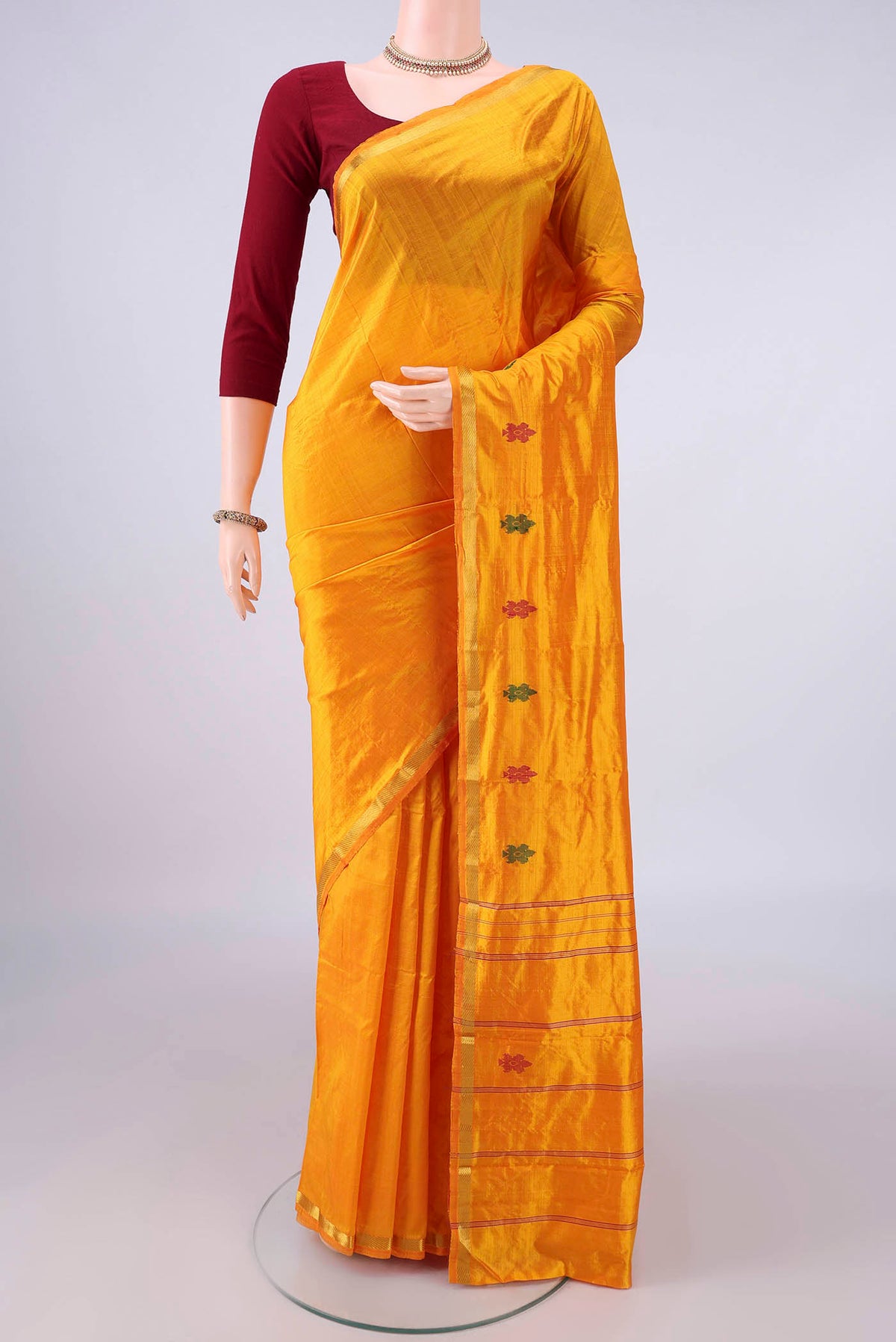 Pure Silk Yellow Kanchipuram Saree with Plain Body and Zari Border.  displayed on a mannequin