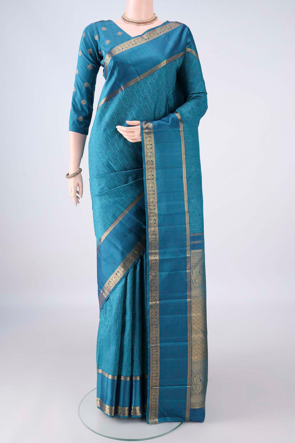 Pure Silk Blue Kanjivaram Saree with Jacquard design on the body and Zari Border.  displayed on a mannequin
